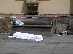 A body is covered on a pedestrian street in Graz, Austria on June 20, 2015 at the scene of an accident. (AFP PHOTO)