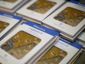 Pope Francis' new encyclical titled "Laudato Si (Be Praised), On the Care of Our Common Home", is displayed during the presentation news conference at the Vatican June 18, 2015. Pope Francis demanded swift action on Thursday to save the planet from environmental ruin, urging world leaders to hear "the cry of the earth and the cry of the poor", plunging the Catholic Church into political controversy over climate change. In the first papal document dedicated to the environment, he calls for "decisive action, here and now," to stop environmental degradation and global warming, squarely backing scientists who say it is mostly man-made. (REUTERS/Max Rossi)