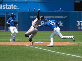 Toronto Blue Jays second baseman Ryan Goins tags out Baltimore Orioles designated hitter Adam Jones during the first inning in a game at Rogers Centre on June 20, 2015. (Nick Turchiaro/USA TODAY Sports)