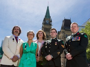 Martin Magnan along with(L-R)Margaret Lerhe, Barbara Winters, Master Corporal Kyle Button, and Colonel Conrad Mialkowski received Gold Life-Saving Medals of the Order of St. John on Saturday, June 20, 2015 for their efforts in assisting Cpl. Nathan Cirillo after he was shot while on ceremonial sentry duty at the Canadian National War memorial on October 22, 2014. 
Errol McGihon/Ottawa Sun