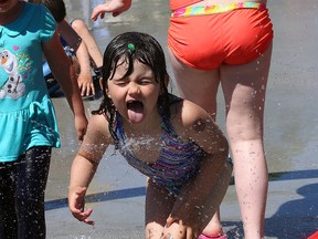 Ciara Wood grabs a drink of water while playing on the splash pad at Victory Park in Sudbury, Ont. on Saturday June 20, 2015. The splash pad was officially opened during a ceremony which recognized the contribution of the City of Greater Sudbury,  the Ontario Trillium Foundation, DEWCAN, the Loyal Order of Moose Sudbury Lodge 230 and the local community. John Lappa/Sudbury Star/Postmedia Network