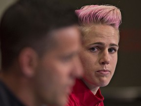 Canada midfielder Sophie Schmidt looks at coach John Herdman as he answers questions from the media prior to training in Vancouver during the FIFA Women's World Cup Canada 2015 on June 20, 2015.  (AFP/ANDY CLARK)