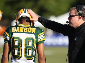 Edmonton Eskimos head coach Chris Jones pats Skye Dawson on the helmet during a Canadian Football League pre-season game against the B.C. Lions at UBC Thunderbird Stadium in Vancouver on Friday. The Eskimos won 18-13 in their final tune-up before the regular season. Carmine Marinelli/Postmedia Network