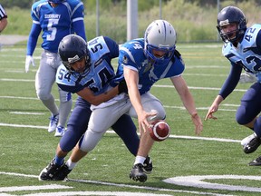 Chris Moutsatsos, right, of the Sudbury Gladiators, fumbles the ball during football action against the Toronto Argos at James Jerome Sports Complex in Sudbury, Ont. on Saturday June 20, 2015. John Lappa/Sudbury Star/Postmedia Network