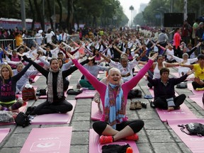 Participants perform yoga to mark the International Yoga Day at Reforma Avenue in Mexico City, June 21, 2015. REUTERS/Tomas Bravo