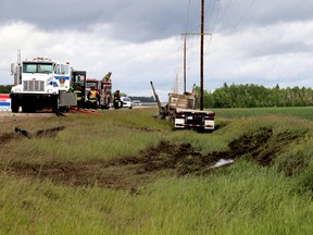 Grande Prairie Rural RCMP and emergency responders tend to the scene of a fatal collision between a pick-up truck and a semi truck on Saturday June 20, 2015 at the intersection between Secondary Highway 672 and Range Road 62, south of Sexsmith, Alta. A female driver was pronounced dead at the scene. Jocelyn Turner/Grande Prairie Daily Herald-Tribune/Postmedia Network