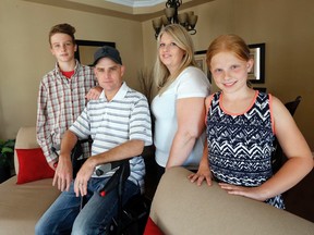 Chris Graham, who has MS, with wife Leah, daughter Jordyn, 10 and son Tyler 13 Thursday June 18, 2015. (Michael Peake/Toronto Sun)
