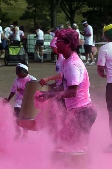 A volunteer prepares to throw some starch in the Pink Zone during the Graffiti Run at Rundle Park in Edmonton, Alberta on Sunday, June 21, 2015. Perry Mah/Edmonton Sun/Postmedia Network