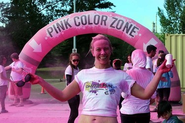 A volunteer pose for a photo in the Pink Zone during the Graffiti Run art Rundle Park in Edmonton, Alberta on Sunday, June 21, 2015. Perry Mah/Edmonton Sun/Postmedia Network