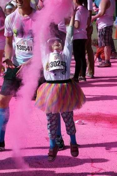 6 year old Teagan Anderson throws some coloured starch in the Pink Zone during the Graffiti Run art Rundle Park in Edmonton, Alberta on Sunday, June 21, 2015. Perry Mah/Edmonton Sun/Postmedia Network
