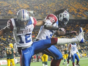 Geoff Tisdale #12 (L) of the Montreal Alouettes celebrates along with his teammate Jerald Brown #39 after stopping Fred Stamps #2 (not pictured) of the Edmonton Eskimos during a CFL game at Commonwealth Stadium on September 12, 2014 in Edmonton, Alberta, Canada. The Eskimos defeated the Alouettes 33-16. (Derek Leung/Getty Images/AFP)