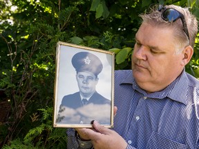 Shawn Williams stares at an old photograph of his deceased father Ted Williams on Friday June 19, 2015. 
Errol McGihon/Ottawa Sun