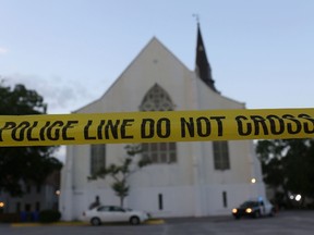 Police tape is seen near the Emanuel African Methodist Episcopal Church before it is opened for a Sunday service. Nine people were killed in a mass shooting at the church in Charleston, S.C. (GETTY IMAGES)