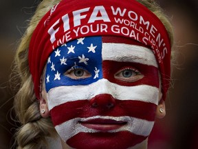 A USA fan watches the team warm up prior to a Group C football match between Nigeria and USA at BC Place Stadium in Vancouver during the FIFA Women's World Cup Canada 2015 on June 16, 2015.  AFP PHOTO/ANDY CLARK