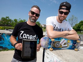Skateboarders and ZonedIn app creators John Galbraith, left, and Brad Smith, right, show off their mobile boarding app at London?s Carling Heights skatepark. (CRAIG GLOVER, The London Free Press)