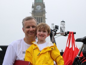 Four-year-old Max Sedmihradsky grins with dad Andrew on a misty morning on Sunday,June 21, 2015 on  Parliament Hill. The pair then set out on a 600-km bike ride to Hamilton, dubbed Max's Big Ride, to raise money for and awareness of Duchenne muscular dystrophy, a debilitating and fatal illness condition. 
TONY SPEARS/Ottawa Sun