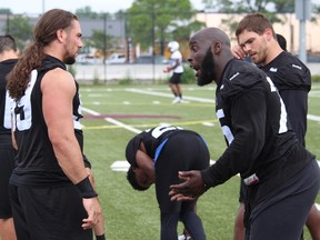 Ottawa RedBlacks defensive lineman Jonathan Williams talks to Connor Williams during practice on Sunday at Gee-Gees Field. TIM BAINES/OTTAWA SUN