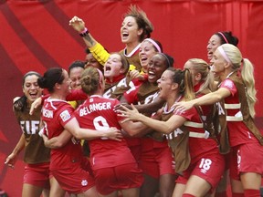 Josee Belanger #9 of Canada is congratulated by teammates after scoring Canada's first goal during the FIFA Women's World Cup Canada 2015 Round 16 match between Switzerland and Canada June 21, 2015 at BC Place Stadium in Vancouver, British Columbia, Canada.  (Jeff Vinnick/Getty Images/AFP)