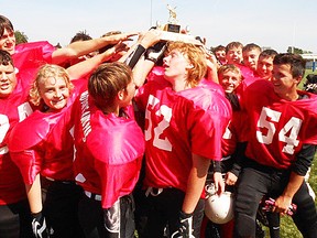 The Hotch's Auto Parts Razorbacks celebrate their A Final championship victory band an undefeated season Saturday at MAS Park Field 2. (James Hurst for The Intelligencer)