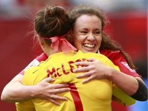 Erin McLeod #1 of Canada is hugged by teammate Allysha Chapman #15 of Canada #15 after their win during the FIFA Women's World Cup Canada 2015 Round 16 match between Switzerland and Canada June 21, 2015 at BC Place Stadium in Vancouver, British Columbia, Canada. Canada won 1-0.   Jeff Vinnick/Getty Images/AFP