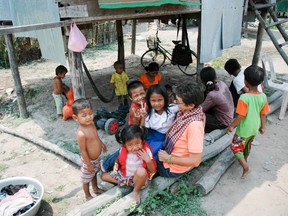 Eyes of Leah's Adele du Plessis sits with some of the children in the Siem Reap region of Cambodia. 
submitted photo for SARNIA THIS WEEK.