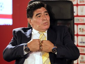 A picture taken on May 4, 2015 at the King Hussein Convention Center in the Dead Sea resort of Shuneh, shows Argentina's legendary ex-footballer Diego Maradona gesturing during the Soccerex Asian Forum on developing the business of football in Asia. (AFP PHOTO / KHALIL MAZRAAWI)
