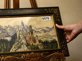 A painting of Neuschwanstein Castle, a watercolor signed A Hitler, is displayed on June 11, 2015 in the Weidler auction house in Nuremberg, southern Germany. Watercolour paintings and drawings by Adolf Hitler from about a century ago were sold at auction in Germany at the weekend for nearly 400,000 euros ($450,000), organisers said. AFP PHOTO / CHRISTOF STACHE