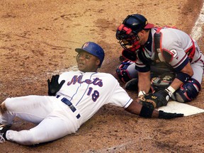 New York Mets' Darryl Hamilton gets tagged out at the plate in the bottom of the third inning by Atlanta Braves catcher Javy Lopez to end the inning at Shea Stadium in New York June 23, 2001. (Postmedia Network file photo)