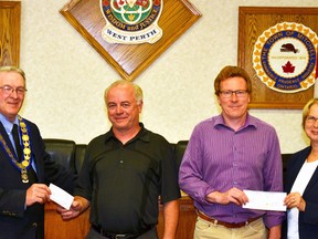 West Perth Mayor Walter McKenzie (left) and municipal treasurer Karen McLagan (right) accepted $5,000 each from Kinsmen Park committee chair Doug Wolfe and Mitchell Minor Sports President Dean Smith. The two delegates repaid the more than a decade-old $10,000 loan from the municipality to the committee at the June 15 council meeting. GALEN SIMMONS/MITCHELL ADVOCATE
