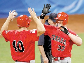 Nick Weglarz (right) of Canada celebrates with Scott Thorman after hitting a home run against Cuba at the Beijing Olympics August 14, 2008. (Postmedia Network file photo)
