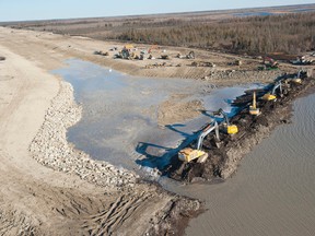 Lake St. Martin residents evacuated in the 2011 flood will soon receive new homes. This photo shows an emergency channel being built in 2012 to drain Lake St. Martin into Lake Winnipeg. (FILE PHOTO)