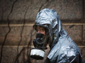 A man in a hazardous materials protective suit. 

REUTERS/Mark Blinch