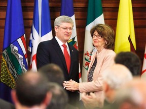 Canada's Prime Minister Stephen Harper (L) shakes hands with Government Leader in the Senate Marjory LeBreton after delivering a speech during a Conservative caucus meeting on Parliament Hill in Ottawa in this May 21, 2013 file photo. LeBreton announced July 4, 2013 that she would resign from Canada's scandal-tinged Conservative government, but gave no reasons. REUTERS/Chris Wattie/Files
