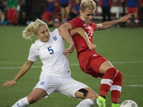 Canada's Sophie Schmidt battles for the ball against England's Steph Houghton during a friendly match in Hamilton, Ont. on May 29, 2015. (Craig Robertson/Postmedia Network)