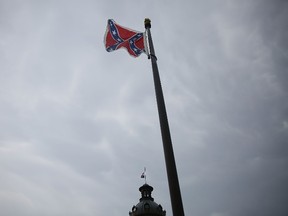 The Confederate flag flies on the Capitol grounds after South Carolina Gov. Nikki Haley announced that she will call for the Confederate flag to be removed on June 22, 2015 in Columbia, South Carolina. Debate over the flag flying at the Capitol was again ignited off after nine people were shot and killed during a prayer meeting at the Emanuel African Methodist Episcopal Church in Charleston, South Carolina.  Joe Raedle/Getty Images/AFP