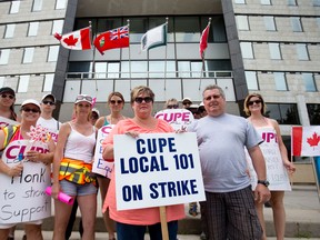 CUPE Local 101 president Shelley Navarroli, centre, stands with fellow striking inside city workers in front of city hall in London, Ont. on Monday June 22, 2015. (CRAIG GLOVER, The London Free Press)