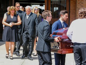 Jeremy Cook?s mother, Melissa, walks behind her son?s casket after his funeral Monday at St. Anne?s church in Brampton. Cook, 18, was shot dead in London last weekend while trying to recover his cellphone. (DAVE THOMAS, Postmedia Network)