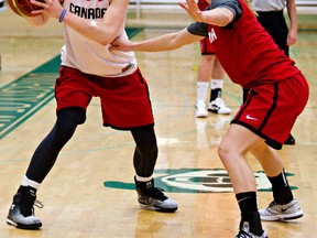 Edmonton's Michell Plouffe, left, plays keepaway with Jamie Weisner during a Team Canada practise at Saville Centre (Codie McLachlan, Edmonton Sun).