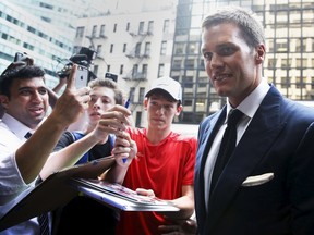 New England Patriot's quarterback Tom Brady arrives at NFL headquarters as people ask for autographs in New York June 23, 2015.   (REUTERS/Shannon Stapleton)