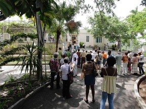 People gather to observe a minute of silence in honor of late Nobel-prize winning author Ernest Hemingway during a simple ceremony at his residence in Cuba, 'Finca Vigia', in Havana July 2, 2011. REUTERS/Desmond Boylan