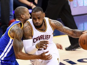 LeBron James of the Cleveland Cavaliers drives against Andre Iguodala of the Golden State Warriors during Game 6 of the NBA Finals at Quicken Loans Arena on June 16, 2015 in Cleveland. (Jason Miller/Getty Images/AFP)