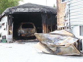 Damage is estimated at $100,000 in this garage fire on Wiltshire Street in Sudbury, Ont. on Tuesday June 23, 2015. The blaze broke out at 4:31 am,  with 17 firefighters from 3 stations fighting the fire .Gino Donato/Sudbury Star/Postmedia Network