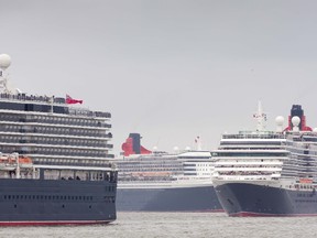 Three Cunard liners named after Royal monarchs, (L-R) Queen Elizabeth, Queen Mary and Queen Victoria perform a synchronized manoeuvre on the River Mersey in Liverpool, north west England on May 25, 2015. The liners are visiting the city during a weekend of celebrations to mark the 175th anniversary of the Cunard Line. 
 AFP PHOTO / CUNARD / CHRIS ISON