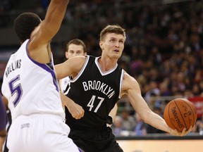 Andrei Kirilenko (right) of the Brooklyn Nets handles the ball against Ryan Hollins of the Sacramento Kings during the 2014 NBA Global Games at the MasterCard Centre in Beijing on October 15, 2014, (AFP PHOTO)