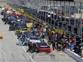 Drivers make a pit stop during the NASCAR XFINITY Owens Corning AttiCat 300 at Chicagoland Speedway on June 21, 2015 in Joliet, Illinois. (Jonathan Daniel/Getty Images/AFP)