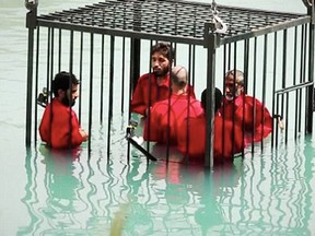 A scene from an ISIS video recently released showing the execution of over a dozen spies by drowning, exploding, and beheading them with explosive cord wrapped around their necks. Handout/Postmedia Network