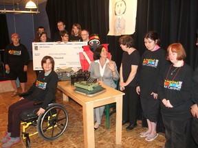 Joining students from the H'art Centre to promote their coming play and book about Mary Macdonald, the disabled daughter of Sir John A. Macdonald who communicated with her father via typewriter, is Josee Theriault, seated behind table, who made a donation to fund the project in Kingston. (Michael Lea /The Whig-Standard)