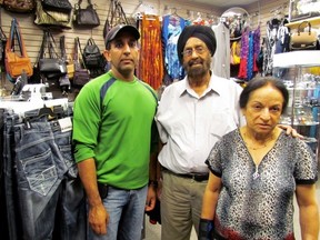 Sarnia's Mamak family are still seeking answers after more than 30 years of government investigations into who is responsible for the Air India flight 182 bombing. From left: Harinderpal, Kalwart, and Gurdeep Mamak are pictured in their family store Mini Accessories in Bayside Mall. (Chris O'Gorman, Sarnia Observer)