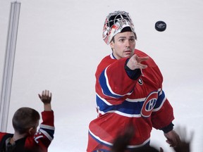 Montreal Canadiens goalie Carey Price throws an autographed puck into the crowd after being awarded the first star of the game for his play against the Toronto Maple Leafs at the Bell Centre on Feb. 28, 2015. (Eric Bolte/USA TODAY Sports)