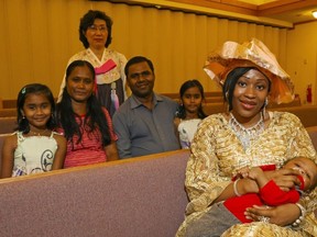 Djeneba Ballo holds her son, Erwan, while sitting with fellow Loyola School of Adult and Continuing Education graduates in Belleville, Ont. Tuesday, June 23, 2015. Seated behind her are Gopal Andiappan Srinivasan, his wife, Geetha, and twins Maadhini, left, and Maathangi Gopal. Standing is Geum Hyang Yu.  

Luke Hendry/The Intelligencer